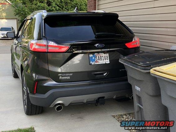 Dark SUV rear with tow receiver, license plate SAB168