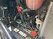 2015 Ford F-550 - The engine bay of a vehicle, a Duracell battery and extensive wiring.