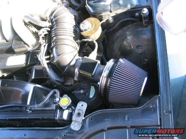 Engine bay with aftermarket air intake and radiator cap