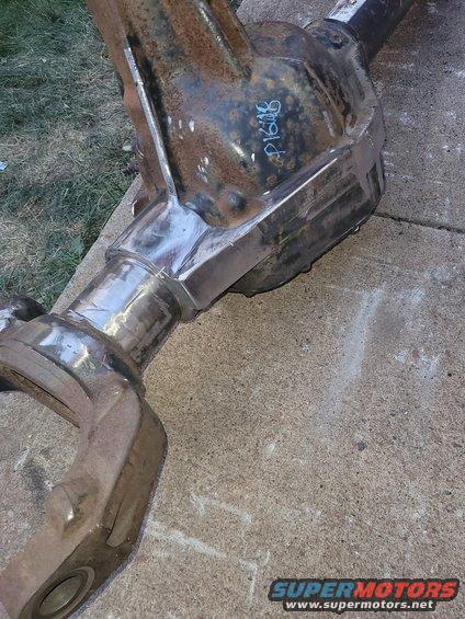 Differential axle with blue writing 'P1608' on a concrete surface