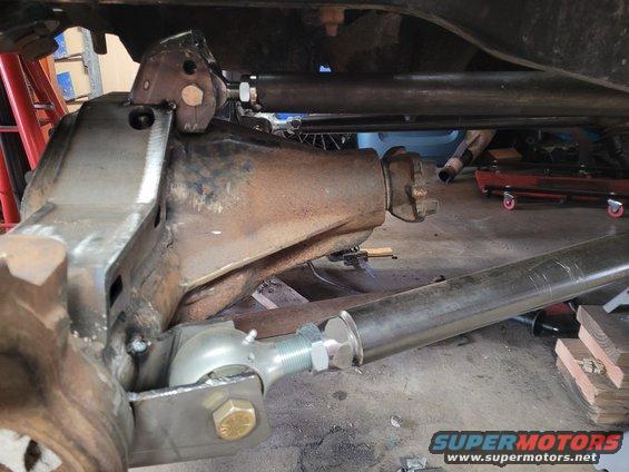 Modified rear axle with adjustable control arms and suspension components. Rusty differential housing