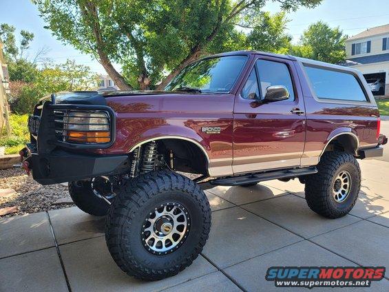 Maroon 1996 Ford Bronco with lifted suspension and off-road tires