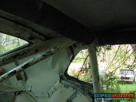 Interior roll cage with view of a white truck outside