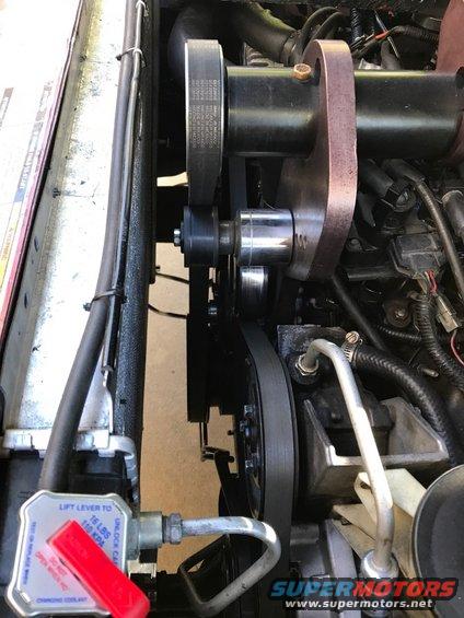Engine cooling system part with belts and pulleys