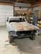 1967 Ford Mustang - A 1967 Ford Mustang is undergoing restoration in a garage, showing its front end with primer and some rust.
