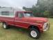 2002 Ford Excursion - This vintage Ford pickup truck, likely from the early 1970s, is equipped with a camper shell, suggesting it's ready for adventure.