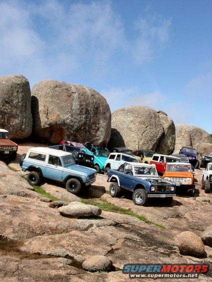 Blue and white Ford Bronco parked on rocks, 1973