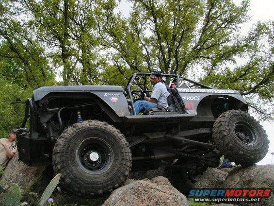 1973 Ford Bronco on rocks, side view, black