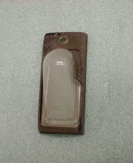 license-plate-light-cover.jpg This is the license plate light's cover.  One philips head screw removed, then pull on tab to have it swing down and off to change the light bulb.  I put in a LED bulb here too.