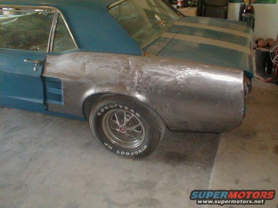 1967 Ford Mustang rear quarter panel with primer and racing stripes