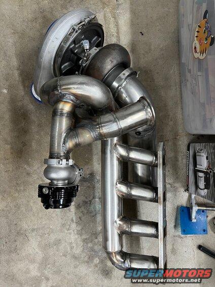 8-assembled.jpg Put the turbo, header, and down pipe stub together to plan out the waste gate merge. I need to put it in the car to check clearance to the control arm though. 