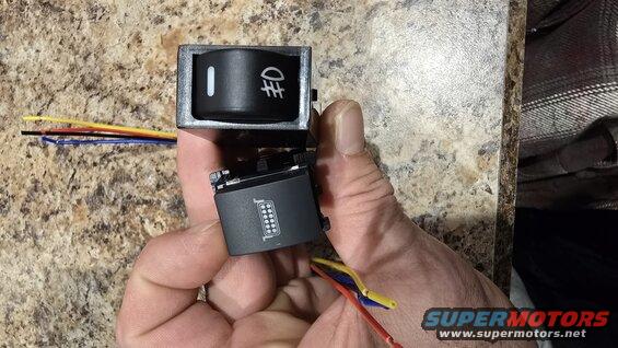 20241206_172546.jpg Push button switches that fit in OEM locations. Left for Baja Designs lower lights (yellow), right will be connected to CANM8 highbeam module to control if upper Aux Beam driving lights come on with high beams