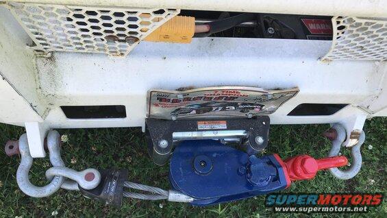 Winch and tow hooks on white truck bumper