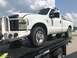2008 Ford F-250 - A white 2008 Ford F-250 pickup truck is seen from a 3q-front angle while being transported on a trailer.