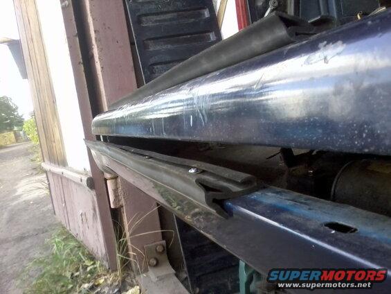 Tailgate weather stripping on a blue vehicle