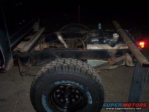 rear of a vehicle frame with suspension and fuel tank visible