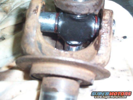 dcp01164.jpg After removing the caps, I positioned the u-joint betweent the two axle pieces. You may have to work it around a little to get it to fit.