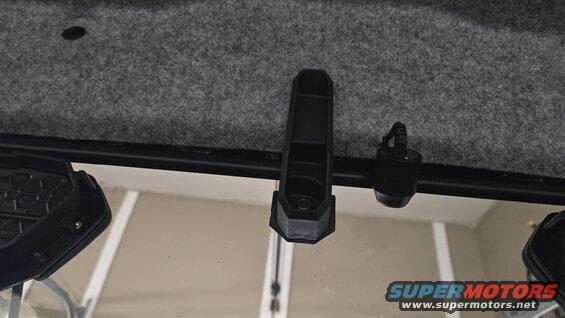 Interior roof lining and windshield frame with a black clip and a small black device attached