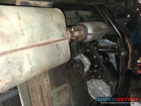 Exhaust muffler with 'FLOWMASTER' text, catalytic converter, and transfer case