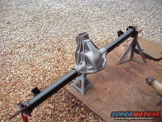 Rear axle assembly on jack stands. Supermotors.net logo in corner