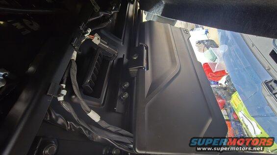 Close-up of interior paneling with visible wiring harness and connectors