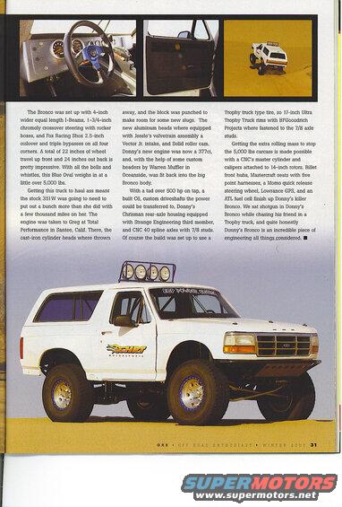 White Ford Bronco with off-road tires and racing decals on a desert landscape.