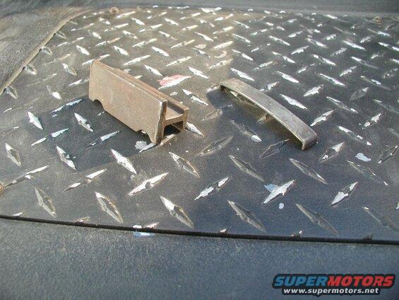 Two metal parts on a diamond plate surface.
