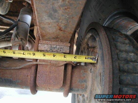 The outside edge of the perch is just about 3" from the backside of the axle flange.