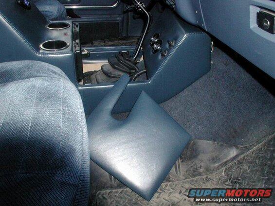 Interior of a vehicle with blue leather center console and removable cover.