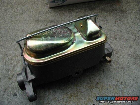 New dark gray master cylinder with gold lid on concrete