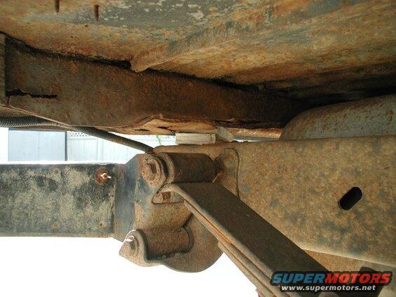 I ground the head off the bolt and pounded it through from the top, then I put some wood in place of the bushing to support the body.