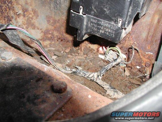 Rusted metal and electrical wiring in a vehicle.