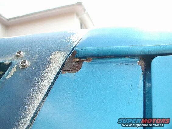 Passenger side, rear of rain gutter.