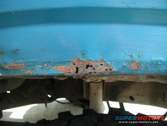 Passenger side, front fender.