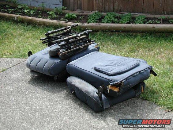 Stacked dark blue car seats with visible metal frames