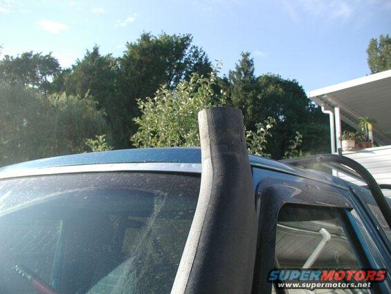 Dark blue SUV with snorkel intake, front passenger side view.