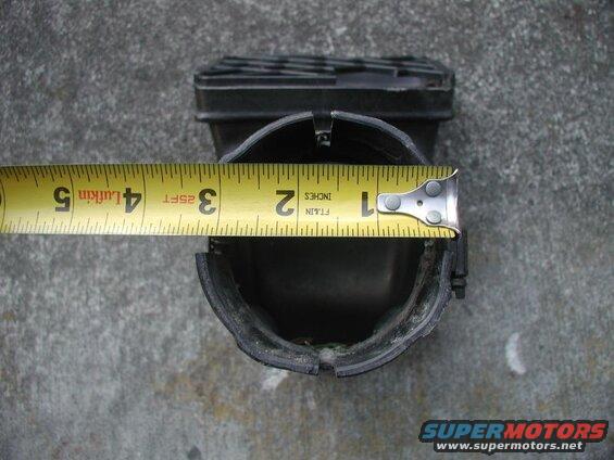Measuring tape across black plastic part, showing approximately 3.5 inches.