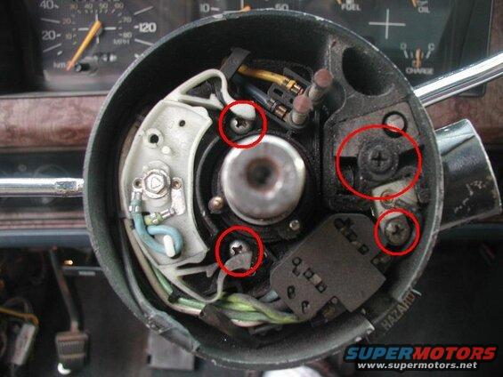 Remove the screw holding the key buzzer terminal and the two screws for the turn signal switch; slide both parts out. Remove the screw right below the steering wheel lock pin and pull out the retaining block.