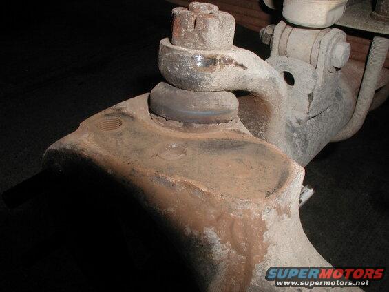 Rusted ball joint assembly on vintage truck or SUV suspension.
