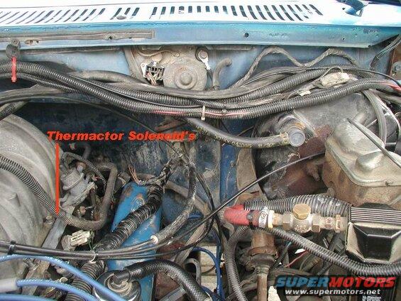 Close-up of engine bay in a blue Ford Bronco, highlighting the thermactor solenoid.