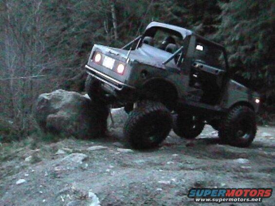 Jay climbs the big rock.