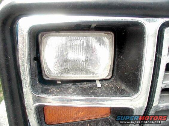 A tree branch hit the right headlight, moving the whole bucket.