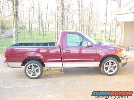 Maroon Ford F-150 pickup truck, side view. Has aftermarket wheels