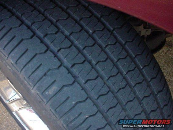 Close-up of a tire tread with a chrome rim visible