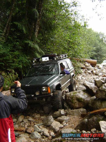 Green Jeep Cherokee on a rocky trail