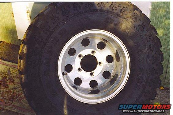 Close-up of a large off-road tire mounted on a polished aluminum alloy wheel