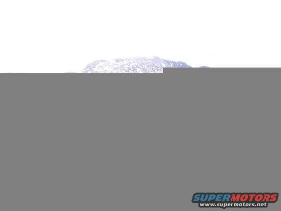 Snow-covered mountain range under a bright, overcast sky.