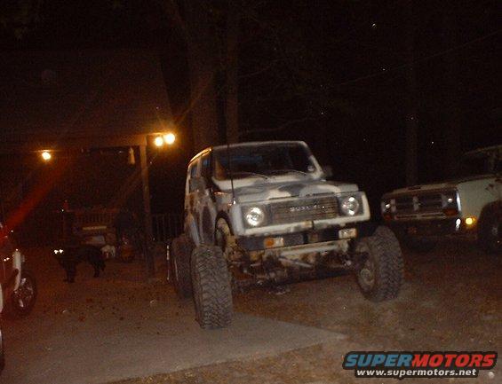 Suzuki Samurai with camouflage paint and large tires, front view