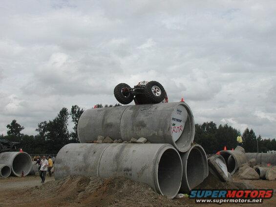 RC monster truck upside down on concrete pipes