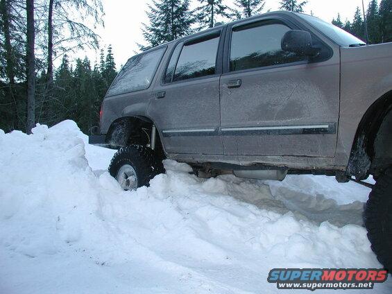 Lifted SUV stuck in deep snow.